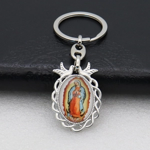 Detailed view of silver metal keychain with Our Lady of Guadalupe religious charm