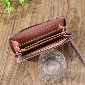 Detail view of pink long zipper wallet showing multiple card slots and coin pocket interior