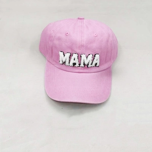 Close-up of pink baseball cap with white MAMA chenille embroidery and washed denim texture