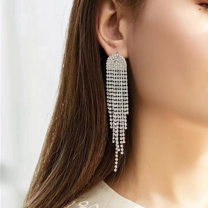 Sparkling silver rhinestone tassel earrings worn by a model for elegant formal events