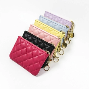 Set of colorful quilted coin purses with gold zippers and chain clips in various pastel tones