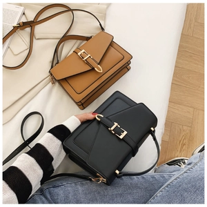 Detail shot of stylish PU leather crossbody bags with golden locks in brown and black