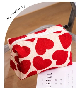 Detailed view of heart-patterned corduroy makeup bag on a tray with lifestyle setting