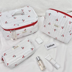 Three-piece quilted makeup bag set with cute cherry print and red zipper details