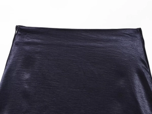Detailed close-up of dark navy satin mini skirt featuring a side invisible zipper