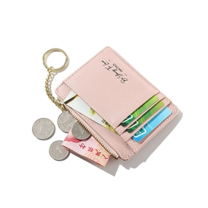 Pink textured leather card holder with gold keychain showing card slots and zipper compartment