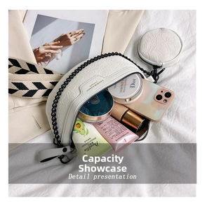 Detail presentation showing internal storage of white embossed crescent crossbody bag