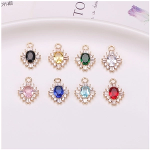 Macro view of eight colorful oval sunflower pendants with gold plating for jewelry making