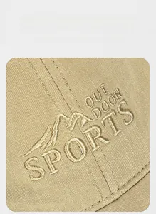 Macro detail of mountain embroidery and Outdoor Sports logo on cotton baseball cap