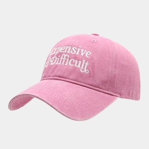 Close-up of pink baseball cap featuring white expensive & difficult embroidery detail