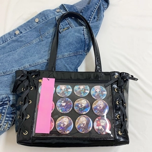 Macro detail of black patent leather ita bag featuring large transparent PVC display window