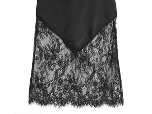 Close-up of black satin dress detailing delicate floral lace trim and smooth fabric