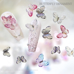 Detailed view of colorful 3D resin butterfly ornaments for nail art and DIY crafts