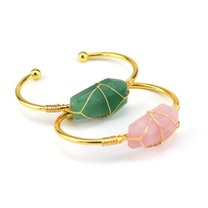 Handmade gold wire-wrapped open cuff bracelet with natural green and pink crystals