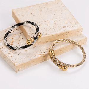 Modern twisted cable bangles in tri-color and gold-silver combinations with ball ends