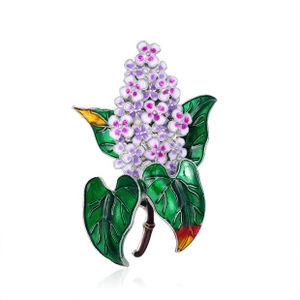 Detailed view of enamel lilac brooch with purple and white flowers and green leaves