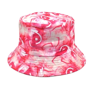 Close-up of abstract pink and red graffiti ink art print on a polyester bucket hat