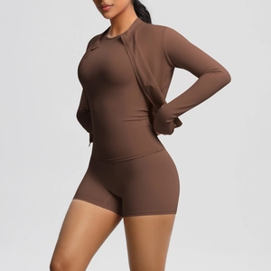 Detail of chocolate brown three-piece yoga set with zippered jacket and slim fit shorts