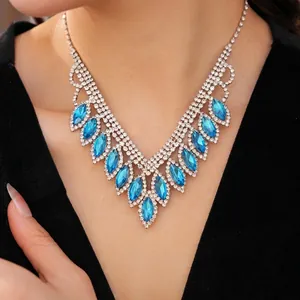 Luxurious blue teardrop pendant necklace with sparkling crystal inlay on model neck