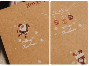 Close-up of kraft paper Christmas stickers with Santa and tree motifs for gift wrapping