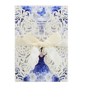 Elegant laser cut wedding invitation with glitter rose patterns and a beige satin bow