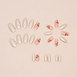 Almond shaped cherry press-on nails set with pearlescent white and hand-painted French tips