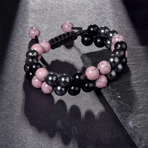 Double-row braided bracelet with 8mm pink turquoise and black stones, adjustable strap