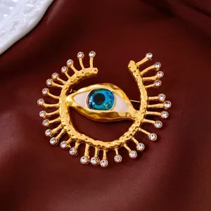 Vintage evil eye brooch in gold finish with blue enamel and white rhinestones