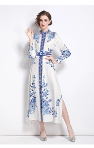 Detailed view of elegant blue floral print on ivory silk dress with waist belt detail