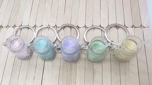 Detailed close-up of colorful bubble tea keychains in five colors on a wooden background