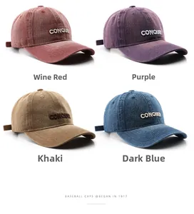 Detail of four washed cotton baseball caps in burgundy, purple, khaki, and navy blue tones