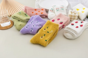 Cosy mink velvet socks with fruit patterns like strawberry and cherry in warm home setting
