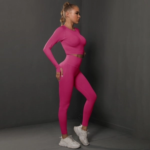 Detail of pink long sleeve yoga top with thumbholes and high waist seamless leggings