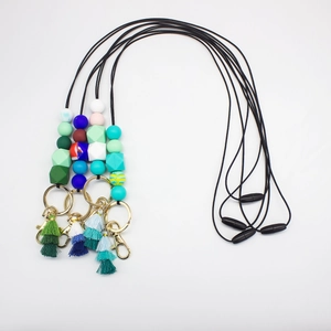 Detail of colorful silicone bead lanyards with metal keyrings and vibrant decorative tassels