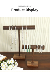 Detail of pearl necklaces and jade bead bracelets on vintage wooden display stand