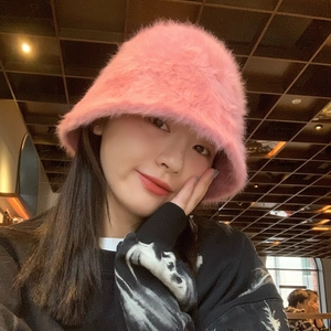 Stylish pink fuzzy bucket hat made of soft faux fur for women's winter warmth