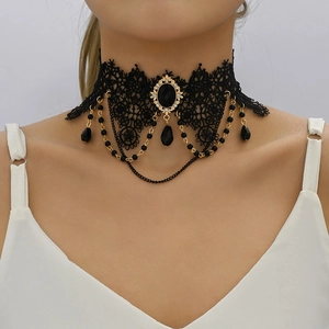 Close-up of black lace choker with gold chain details and dark teardrop pendant