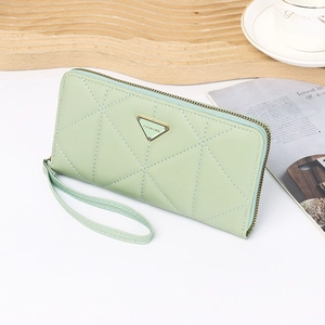 Close-up of mint green zip wallet with diamond lattice stitching and metal fashion plate