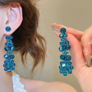 Detail of blue beaded tassel earrings showing faceted crystal shine and long drop design