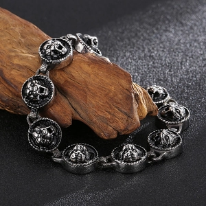 Detailed close-up of a silver tiger head relief on a titanium steel chain bracelet