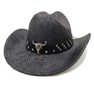 Close-up of black western cowboy hat with snake texture and silver bull skull ornament