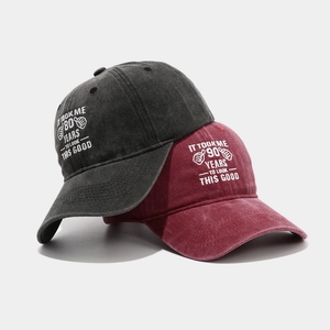 Vintage washed cotton birthday baseball caps in charcoal and wine red with 80th 90th embroidery