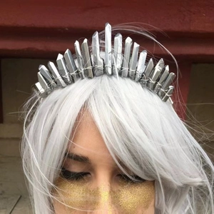 Close-up detail of silver natural crystal crown headband on model with white hair