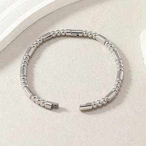 Elegant silver stainless steel bracelet featuring alternating bead and cylinder link design