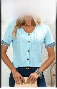 Detail of light blue V-neck top showing textured knit fabric and lace sleeve trim