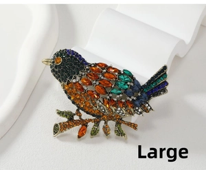 Detailed view of large magpie bird brooch with vibrant multi-color crystals