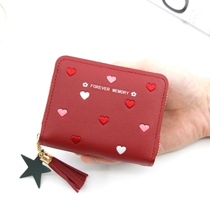 Detailed view of red PU leather wallet featuring heart embroidery and star pendant