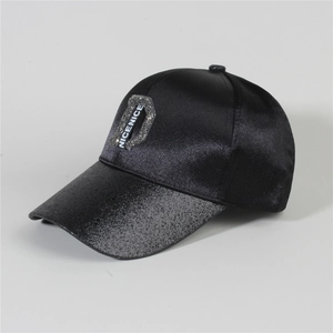Detail of black satin baseball cap with glittery brim and rhinestone NICENICE D patch