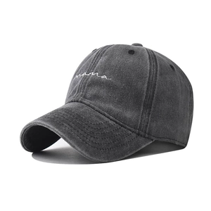Detailed view of white mama embroidery on washed charcoal grey vintage baseball cap