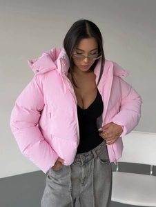 Detail of pink hooded puffer jacket with quilted stitching and zip-up side pockets